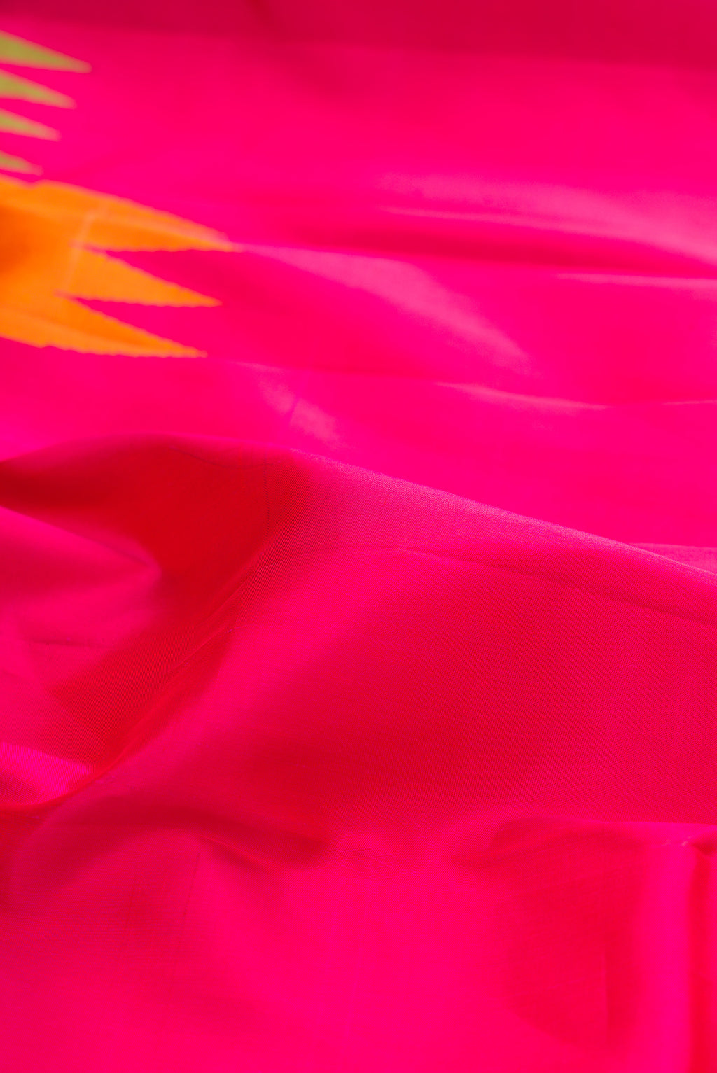 Close up of Pure Silk Pure Zari Pink Kanjivaram Saree with Plain Body and Temple Border.  displaying folds