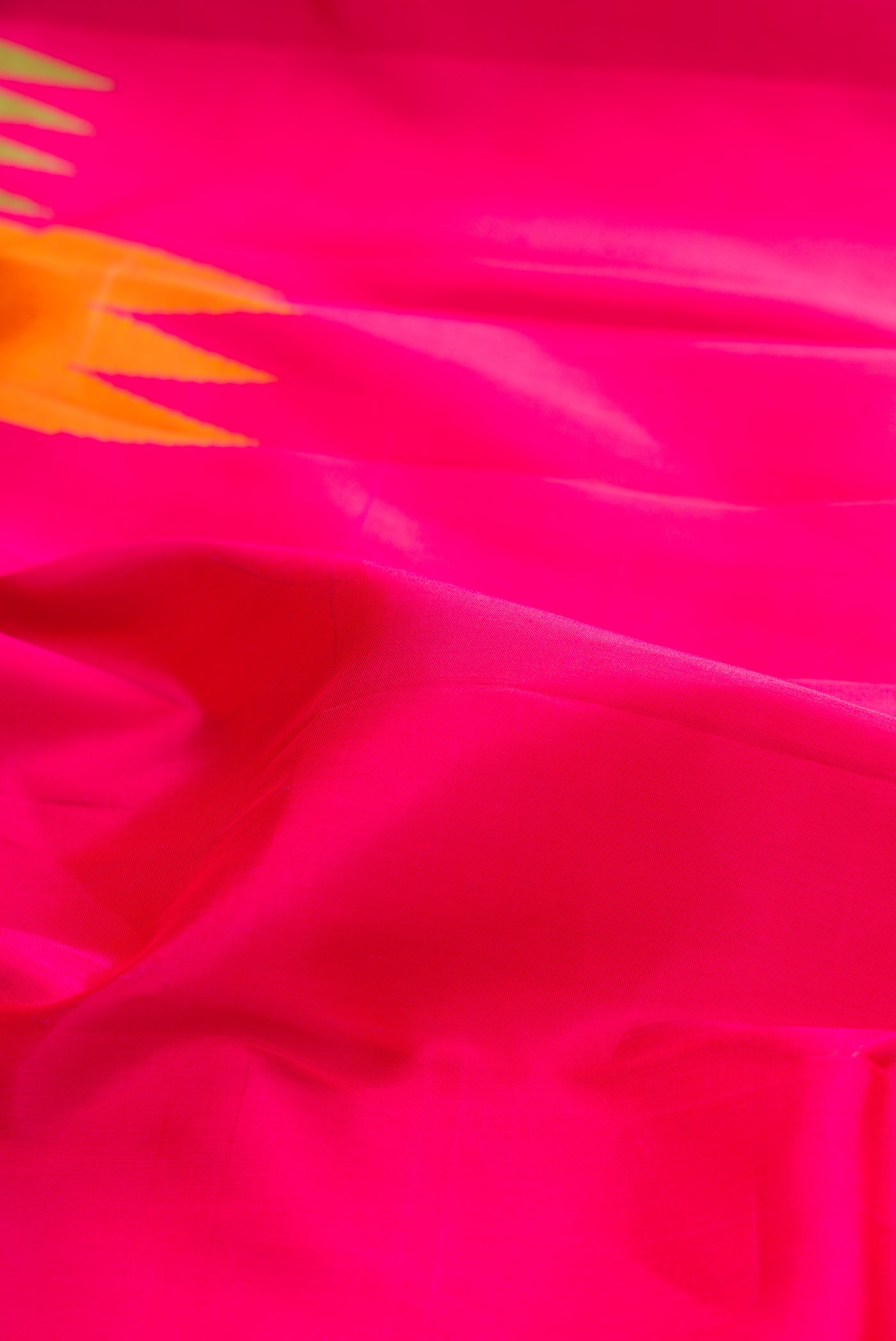 Close up of Pure Silk Pure Zari Pink Kanjivaram Saree with Plain Body and Temple Border.  displaying folds