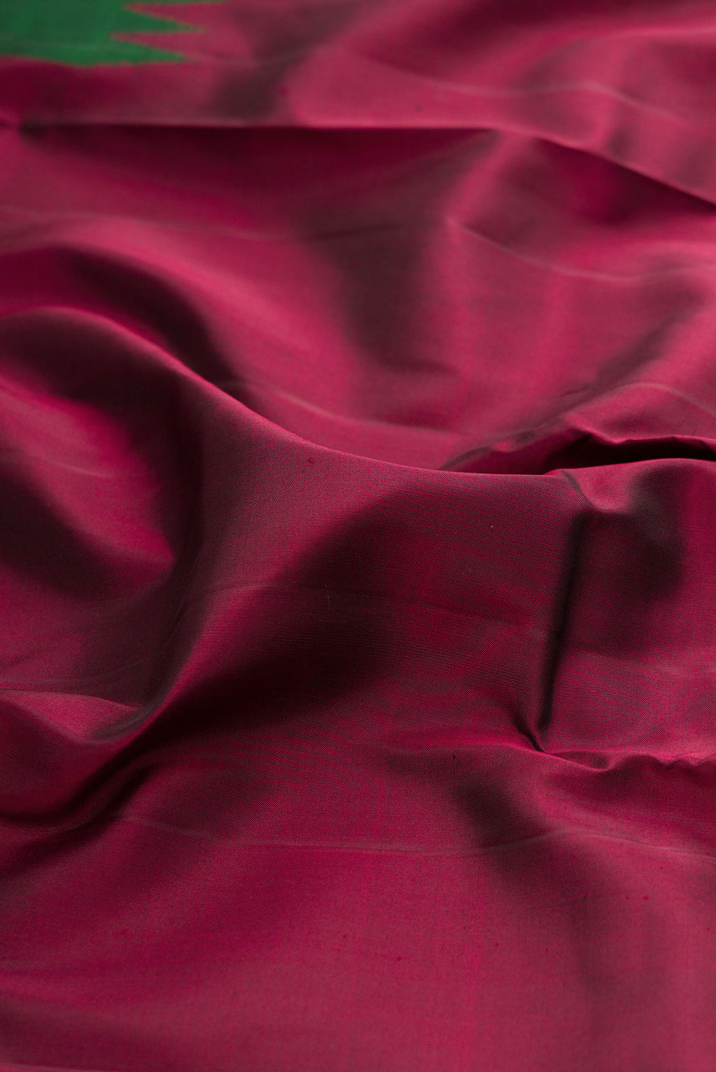 Close up of Pure Silk Pure Zari Maroon Kanjivaram Saree with Plain Body and Fancy Border.  displaying folds