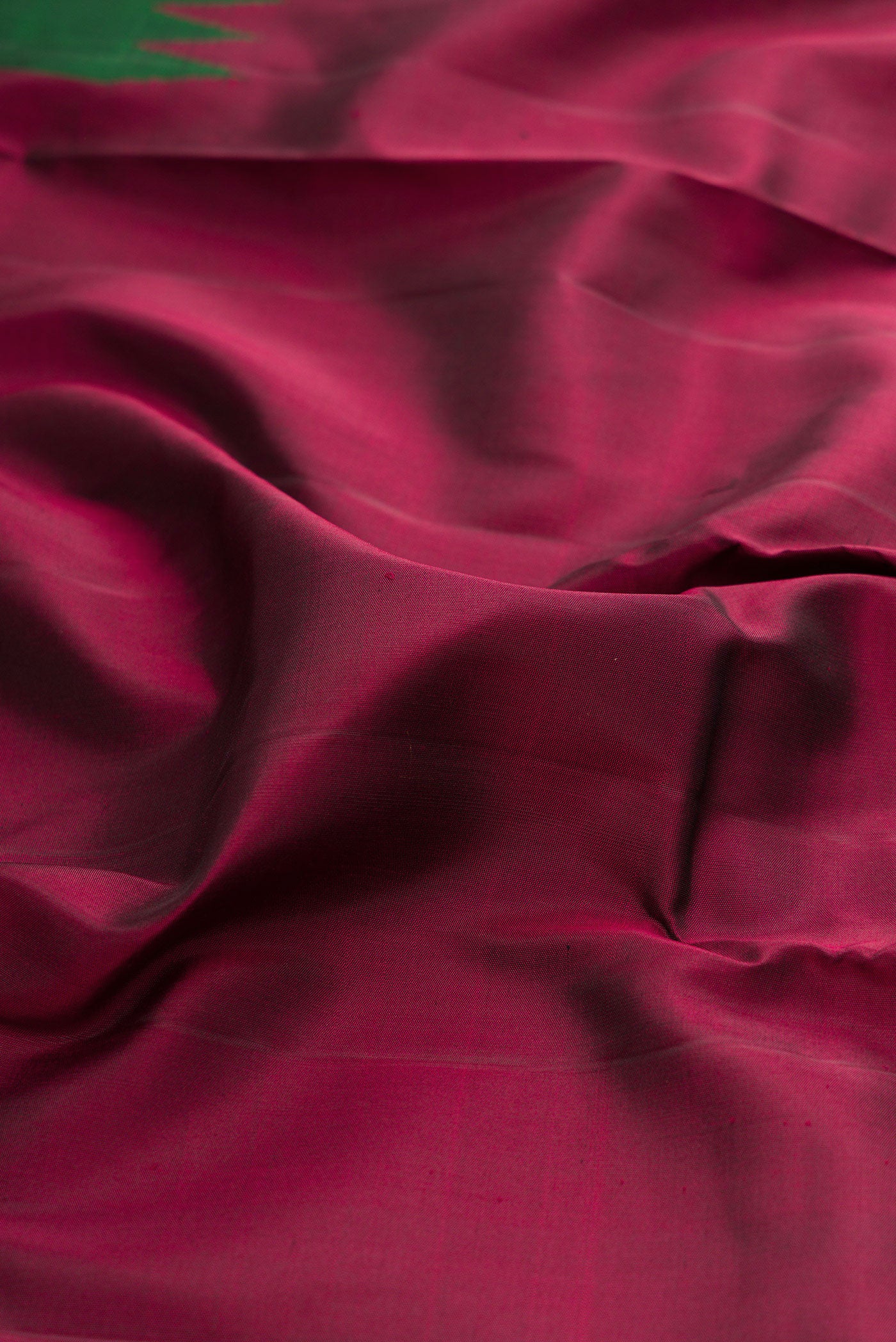 Close up of Pure Silk Pure Zari Maroon Kanjivaram Saree with Plain Body and Fancy Border.  displaying folds