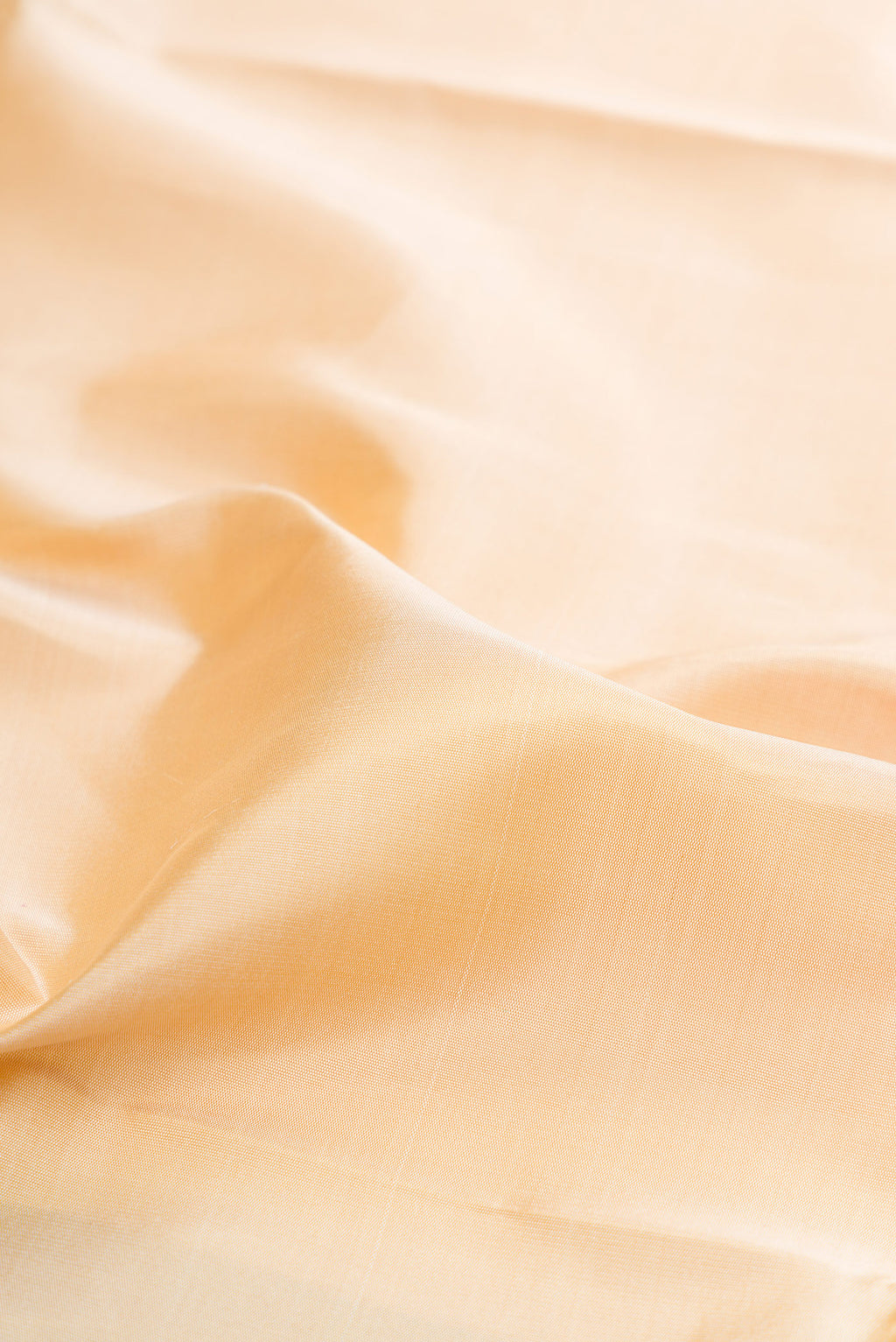 Close up of Pure Silk Pure Zari Beige Kanjivaram Saree with Plain Body and Temple Border.  displaying folds