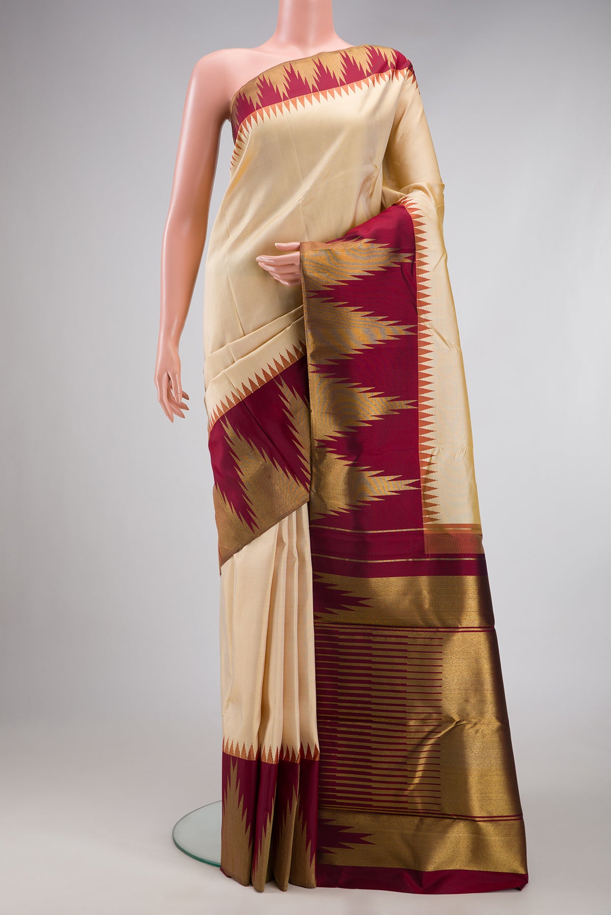 Pure Silk Pure Zari Beige Kanjivaram Saree with Plain Body and Temple Border.  displayed on a mannequin
