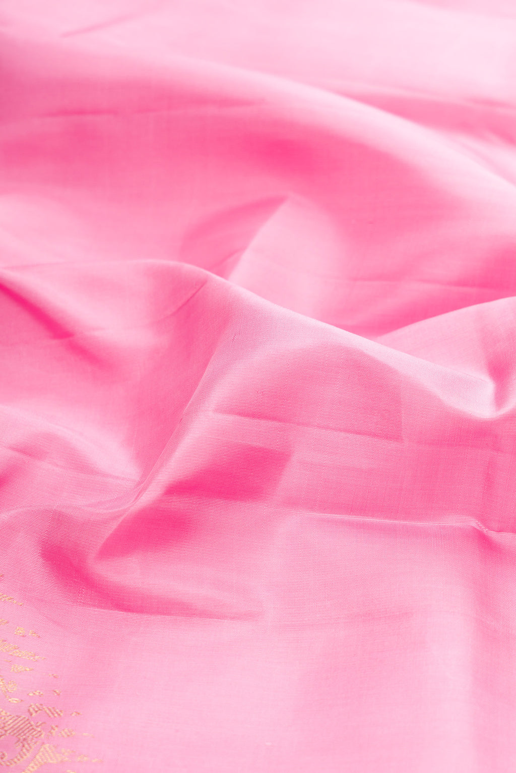 Close up of Pure Silk Pure Zari Rose pink Kanjivaram Saree with Plain Body and Fancy Border.  displaying folds