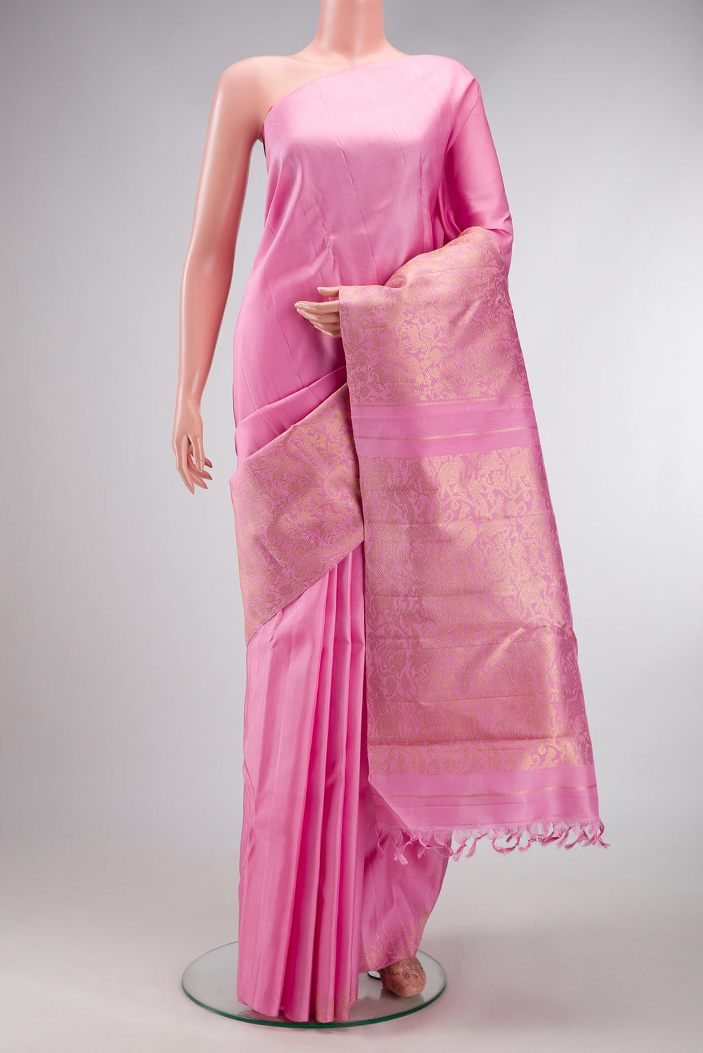 Pure Silk Pure Zari Rose pink Kanjivaram Saree with Plain Body and Fancy Border.  displayed on a mannequin