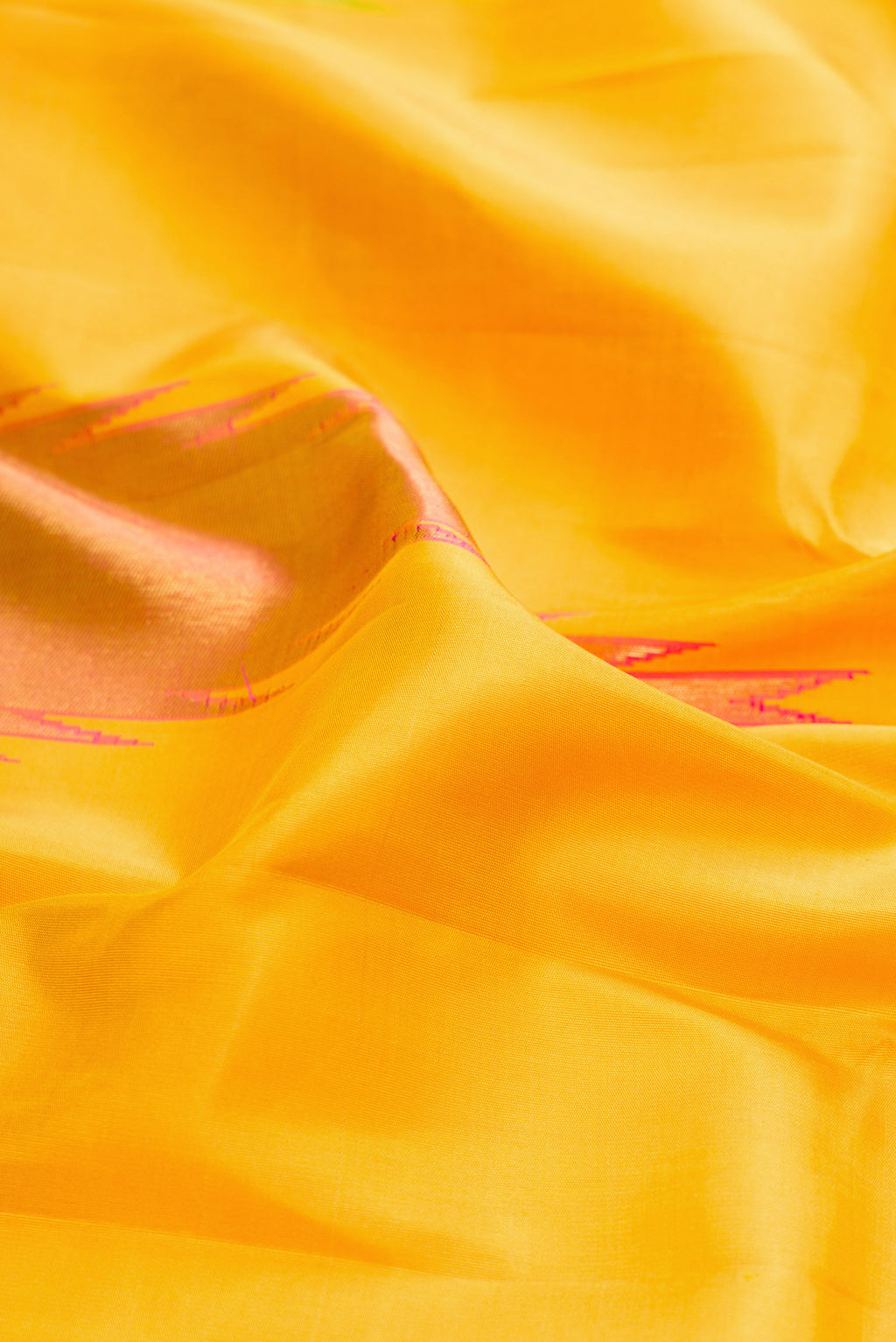 Close up of Pure Silk Pure Zari Yellow Kanjivaram Saree with Plain Body and Temple Border.  displaying folds