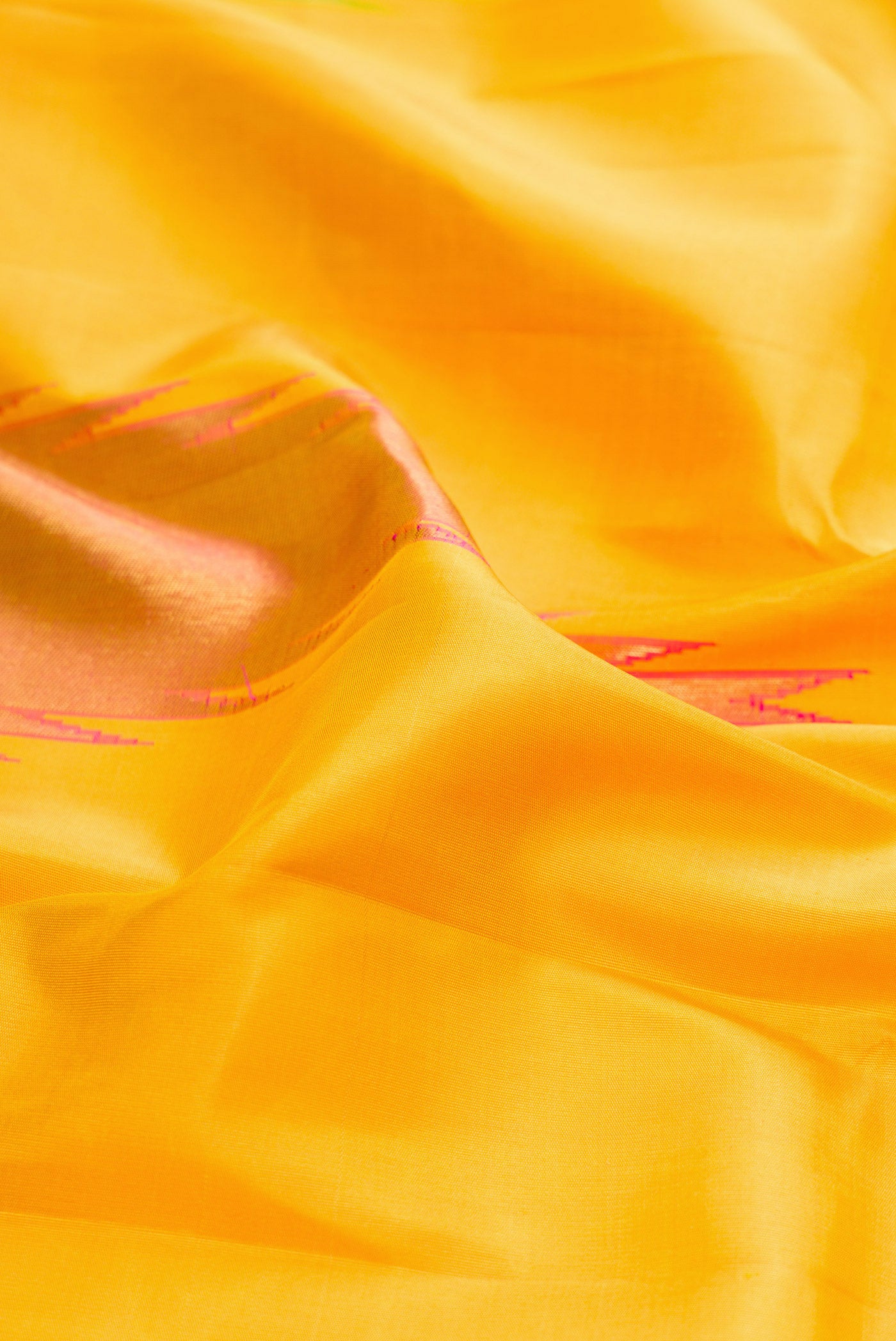 Close up of Pure Silk Pure Zari Yellow Kanjivaram Saree with Plain Body and Temple Border.  displaying folds