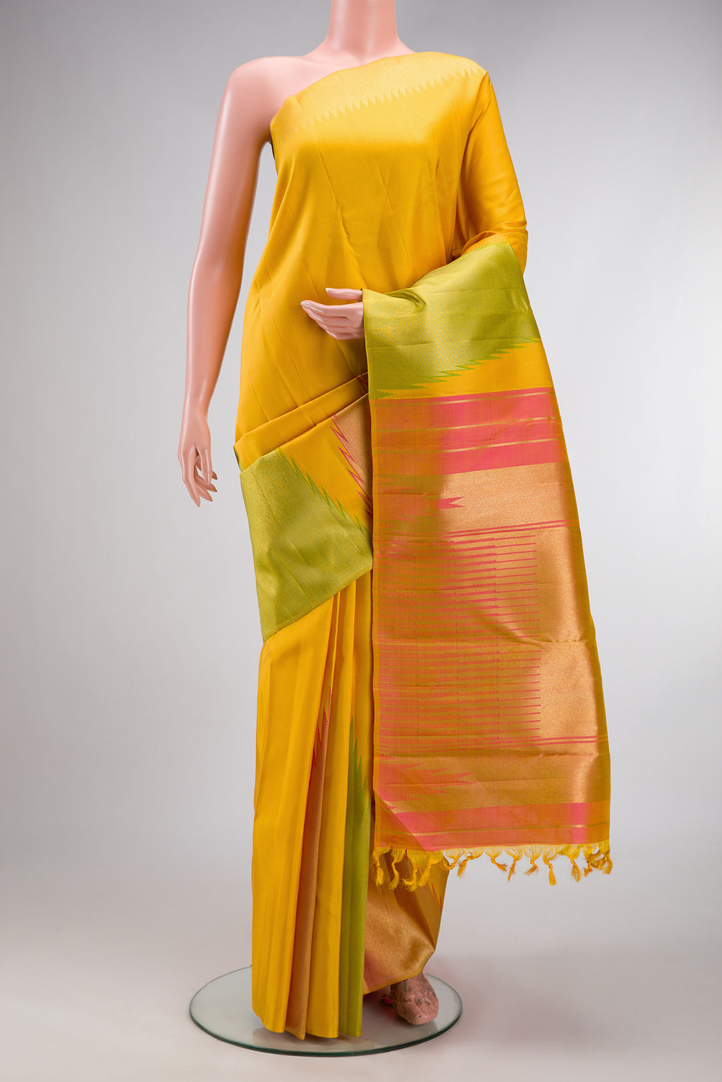 Pure Silk Pure Zari Yellow Kanjivaram Saree with Plain Body and Temple Border.  displayed on a mannequin