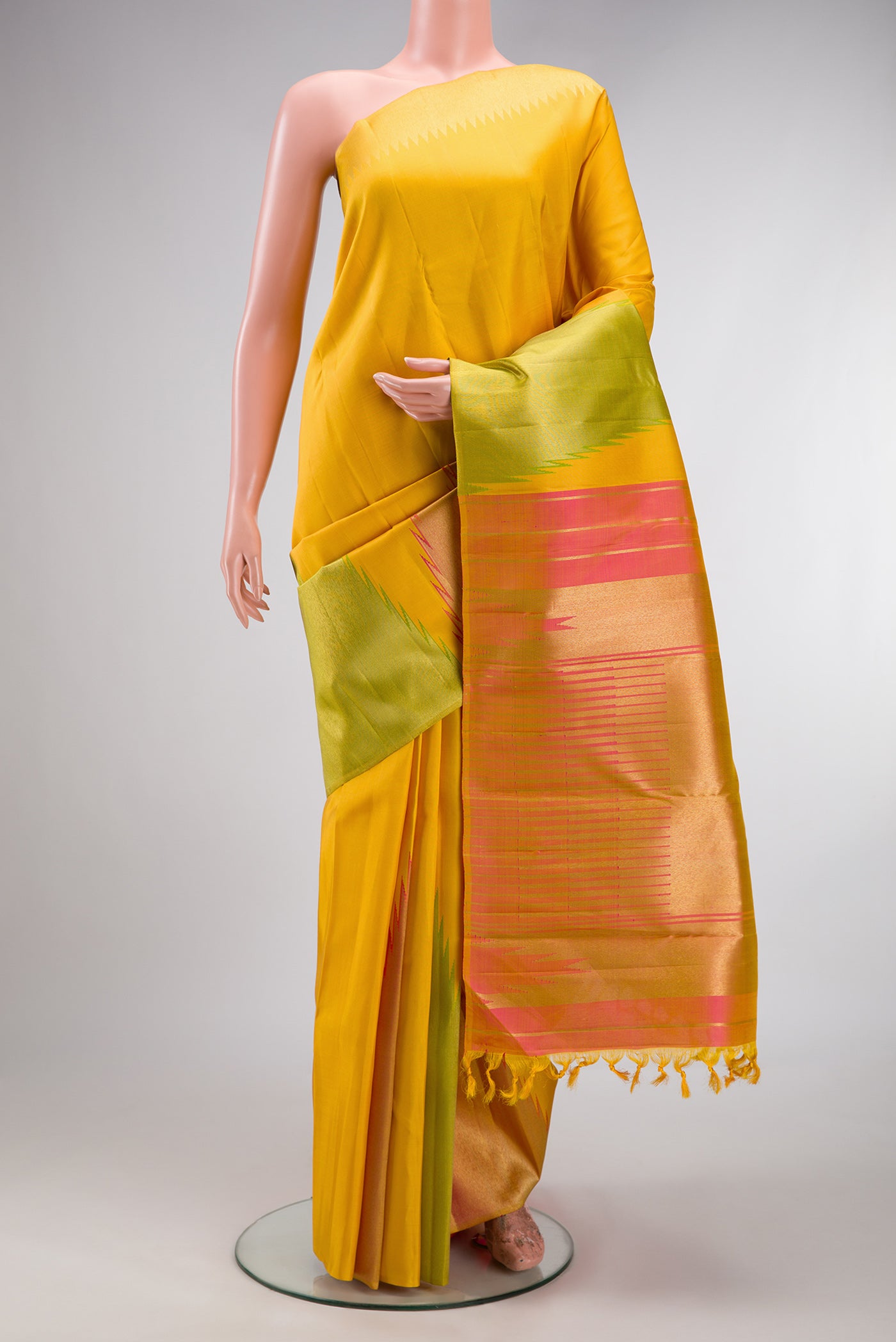 Pure Silk Pure Zari Yellow Kanjivaram Saree with Plain Body and Temple Border.  displayed on a mannequin