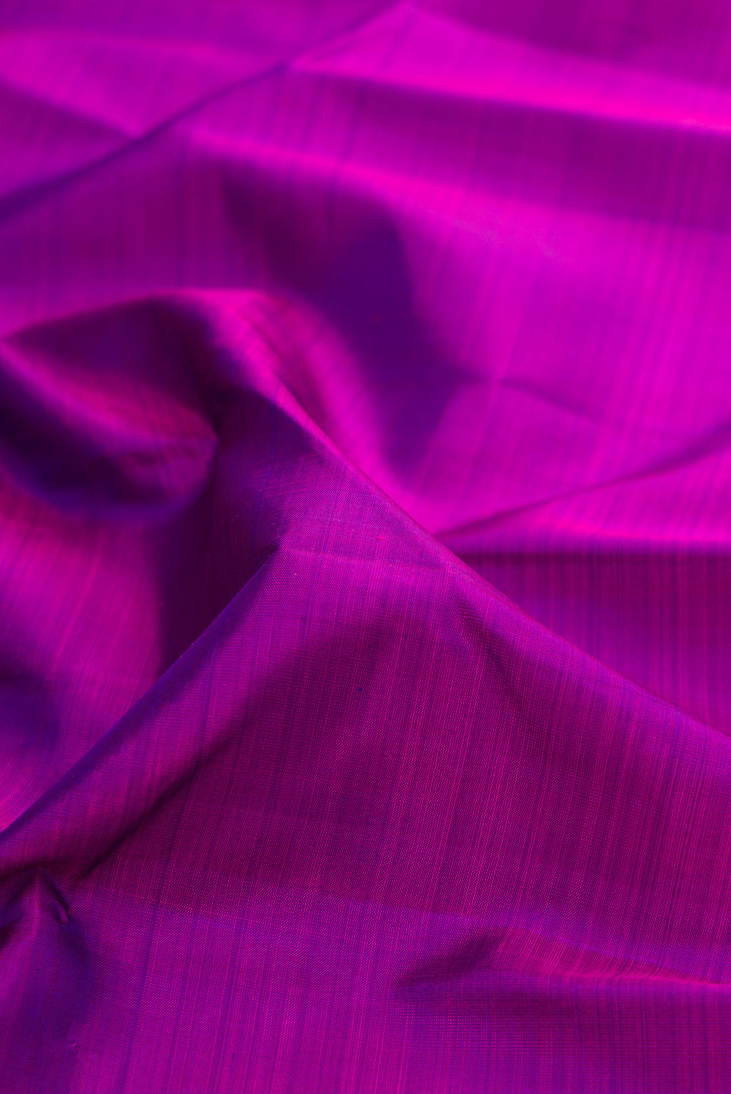 Close up of Purple Kanjivaram Silk Saree with Plain Body and Zari Border.  displaying folds