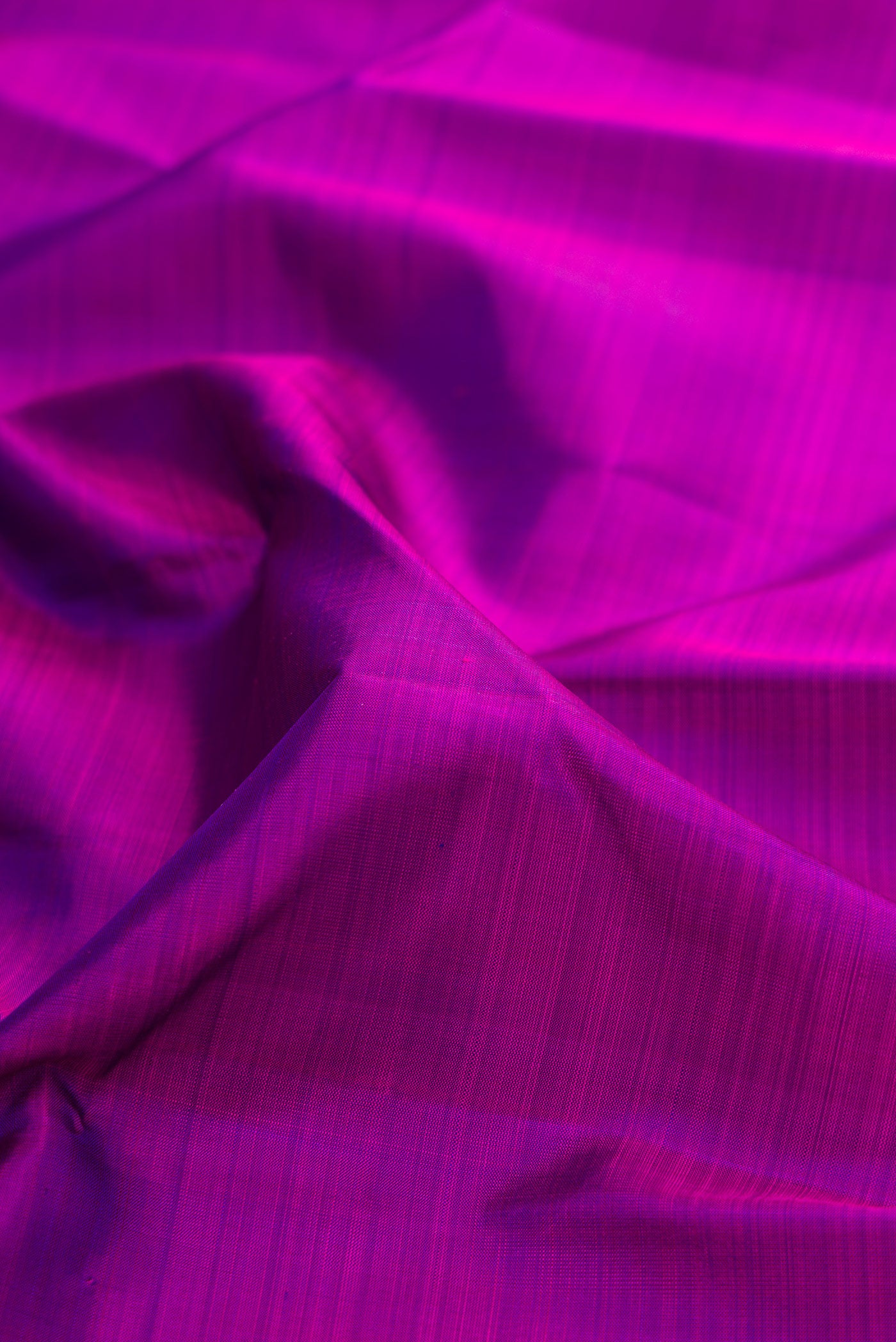 Close up of Purple Kanjivaram Silk Saree with Plain Body and Zari Border.  displaying folds