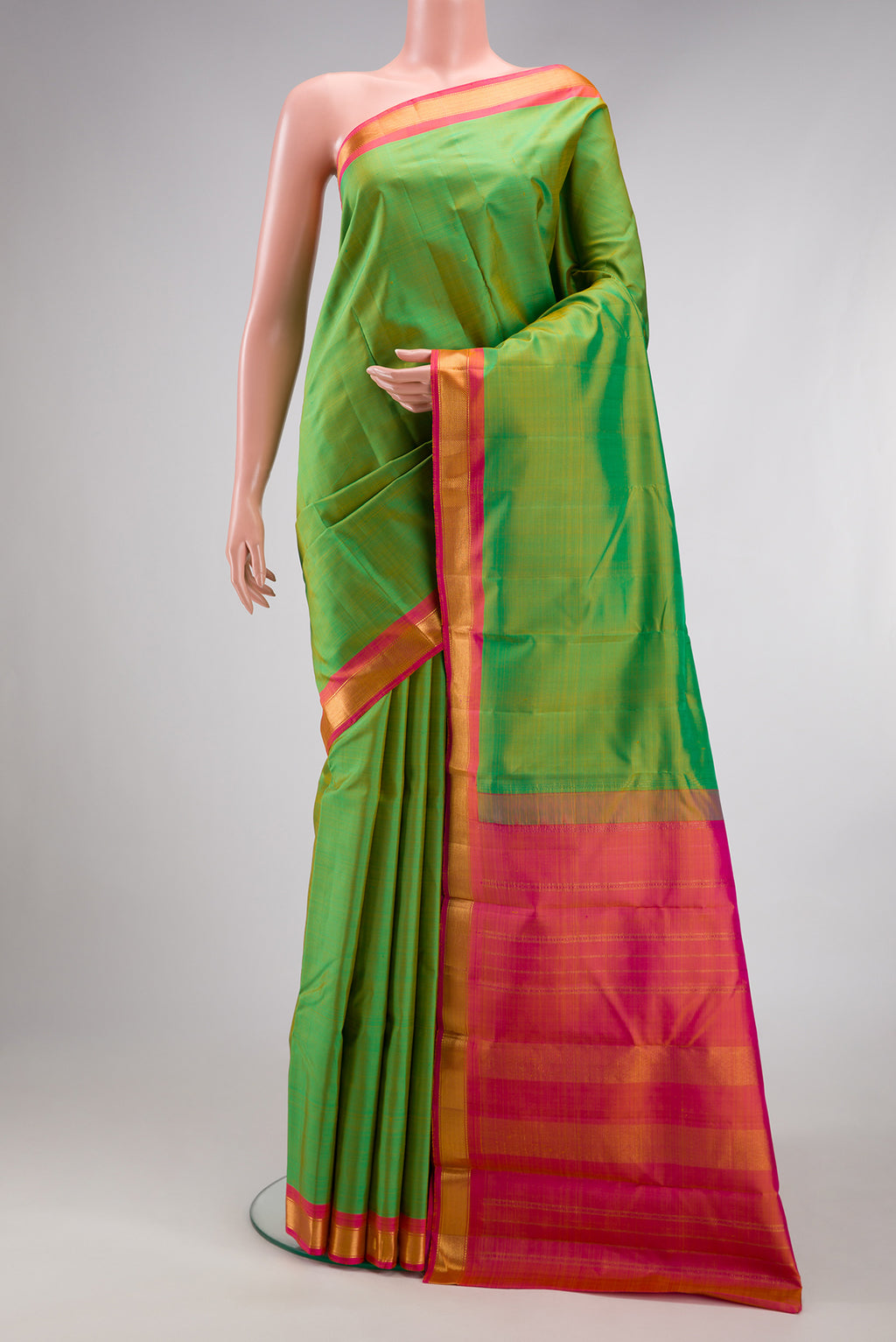 Green Kanjivaram Silk Saree with Plain Body and Zari Border.  displayed on a mannequin