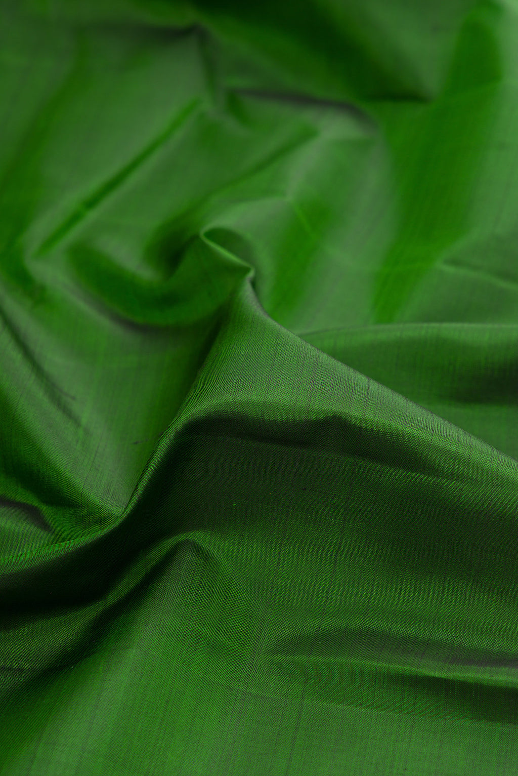Close up of Green Kanjivaram Silk Saree with Plain Body and Zari Border.  displaying folds