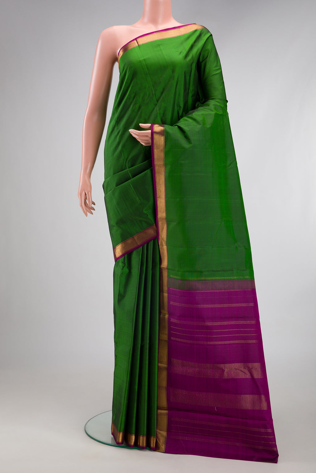 Green Kanjivaram Silk Saree with Plain Body and Zari Border.  displayed on a mannequin