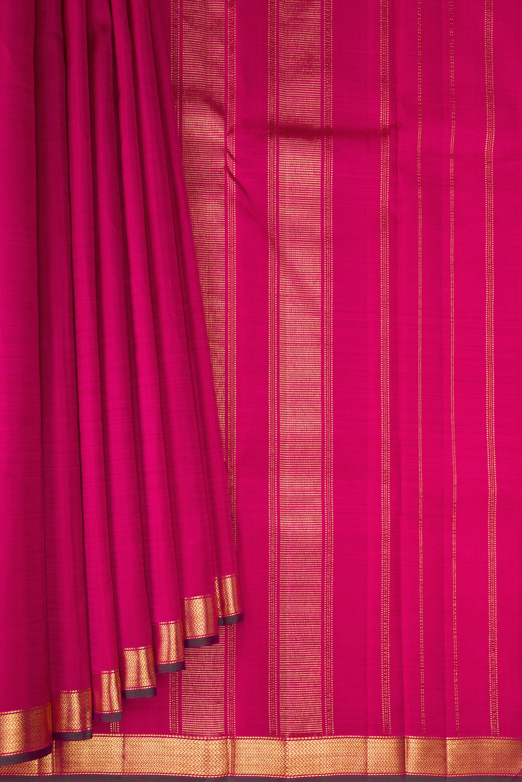 Pleats and pallu of Rani Pink Kanjivaram Silk Saree with Plain Body and Zari Border. 