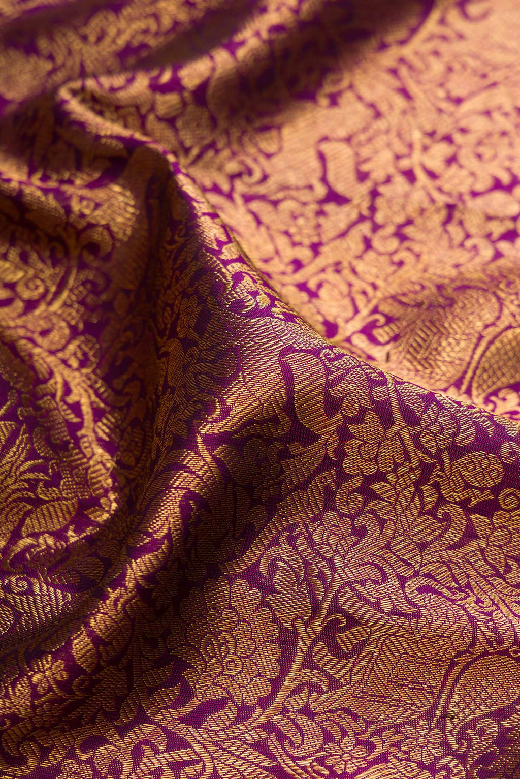 Close up of Pure Silk Pure Zari Purple Kanjivaram Saree with Zari Brocade on the body and Zari Border.  displaying folds