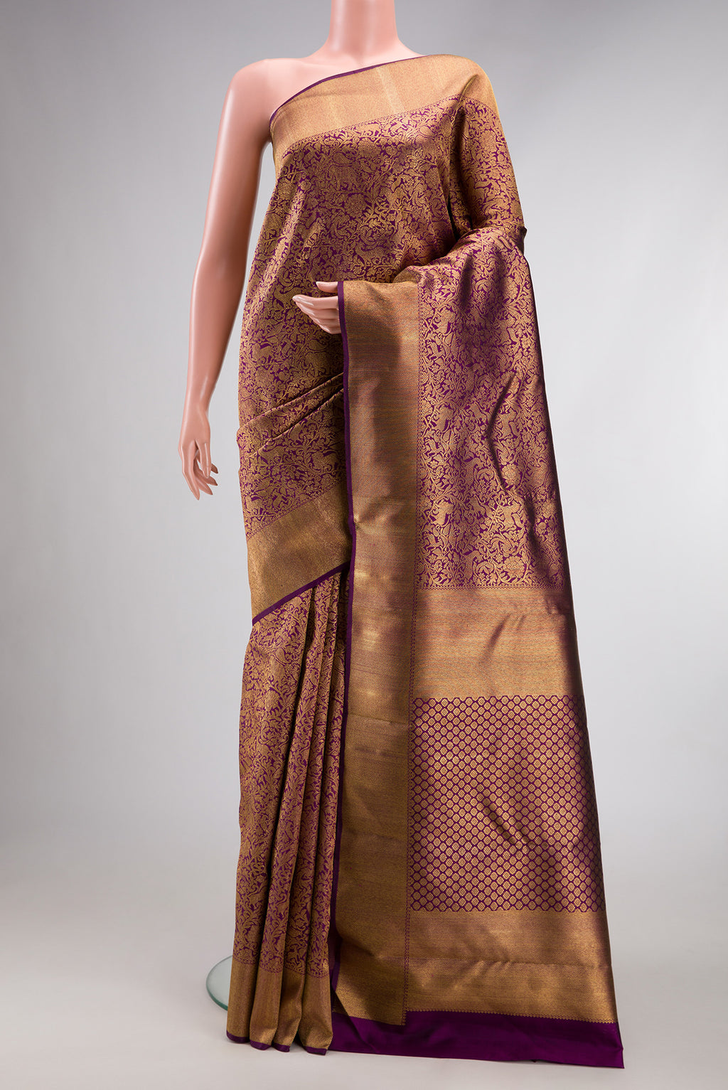 Pure Silk Pure Zari Purple Kanjivaram Saree with Zari Brocade on the body and Zari Border.  displayed on a mannequin