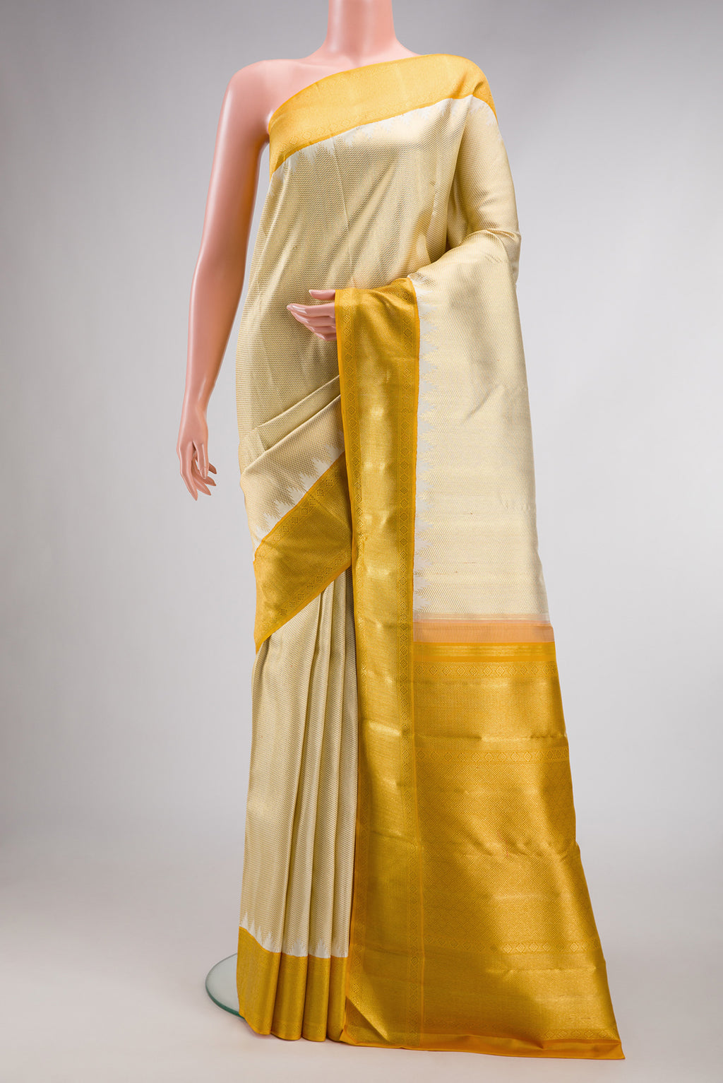 Pure Silk Pure Zari Gold Kanjivaram Saree with Zari Brocade on the body and Zari Border.  displayed on a mannequin