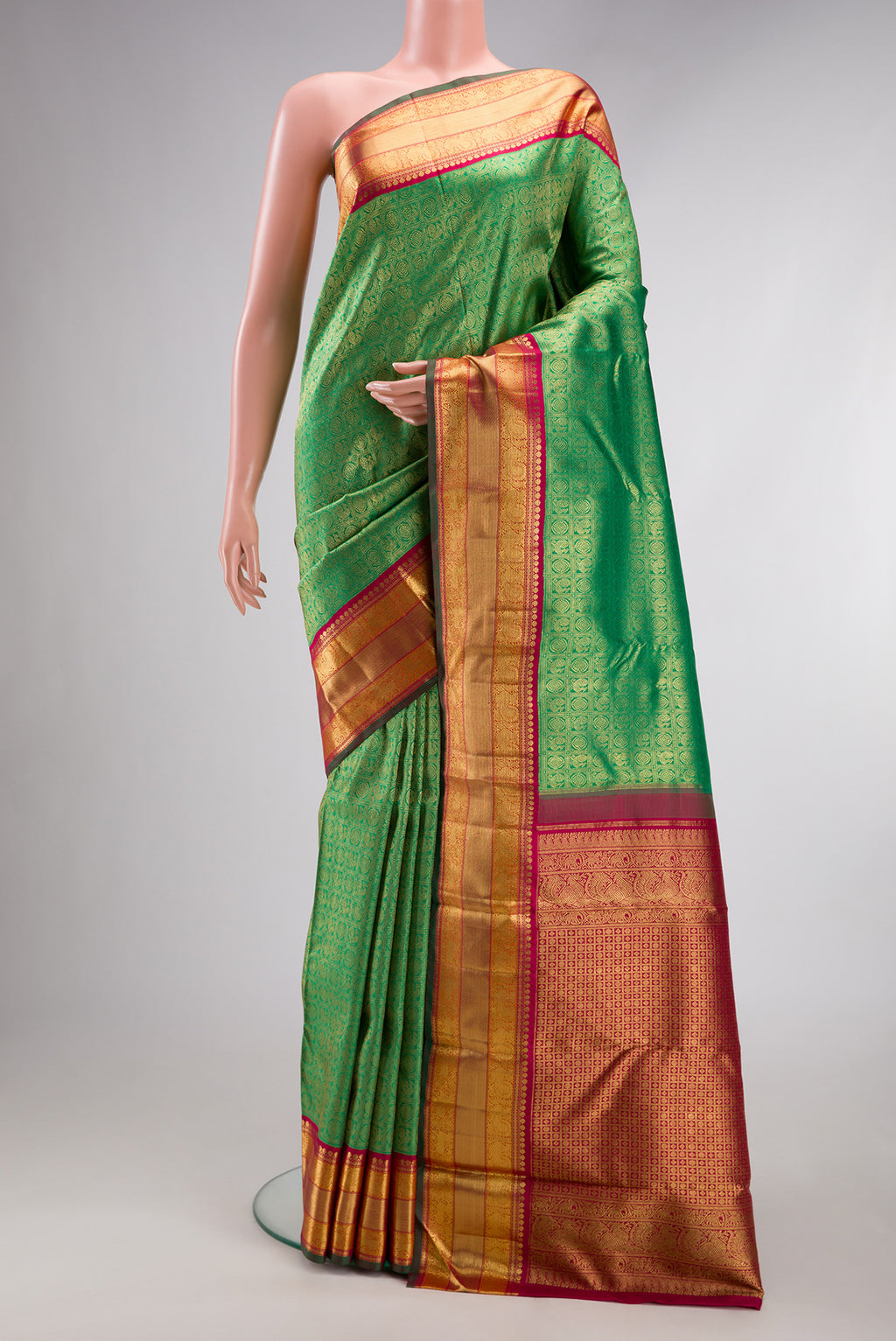 Pure Silk Pure Zari Green Kanjivaram Saree with Zari Brocade on the body and Zari Border.  displayed on a mannequin