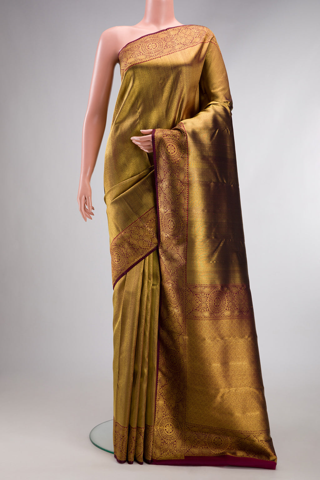 Maroon Dual Tone Kanjivaram Silk Saree with Zari Brocade on the body and Zari Border.  displayed on a mannequin