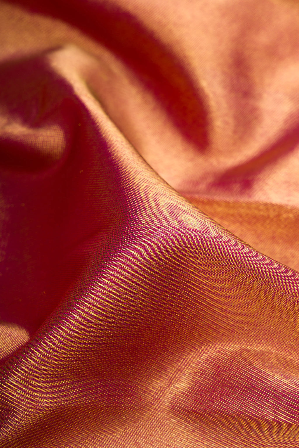 Close up of Pure Silk Pure Zari Magenta Dual Tone Kanjivaram Saree with Zari Brocade on the body and Zari Border.  displaying folds