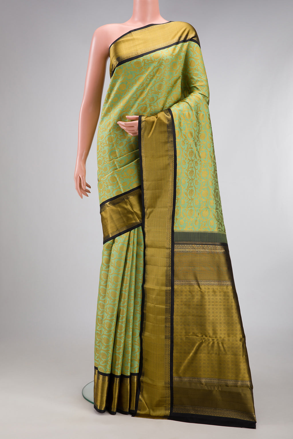 Pure Silk Pure Zari Pista Green Kanjivaram Saree with Jacquard design on the body and Zari And Thread Border.  displayed on a mannequin