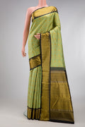 Pure Silk Pure Zari Pista Green Kanjivaram Saree with Jacquard design on the body and Zari And Thread Border.  displayed on a mannequin