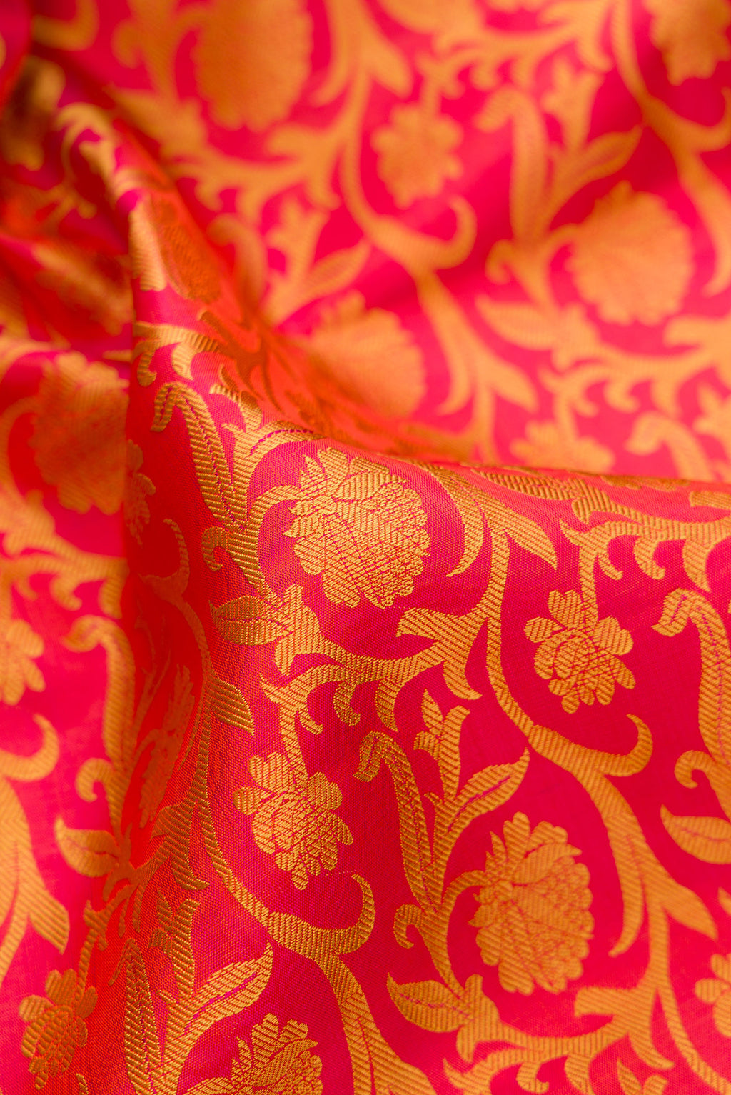 Close up of Pure Silk Pure Zari Orange Kanjivaram Saree with Jacquard design on the body and Zari And Thread Border.  displaying folds