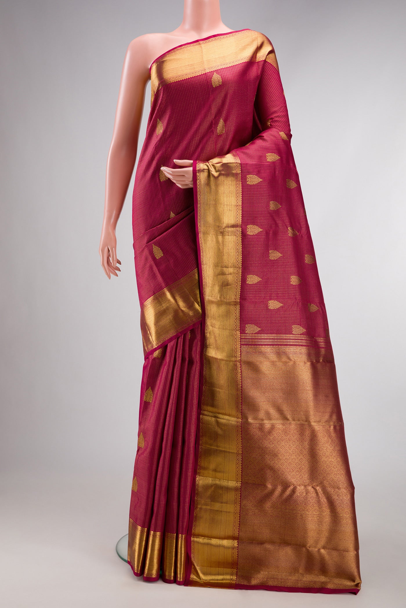 Pure Silk Pure Zari Maroon Kanjivaram Saree with Stripes on the body and Zari Border.  displayed on a mannequin