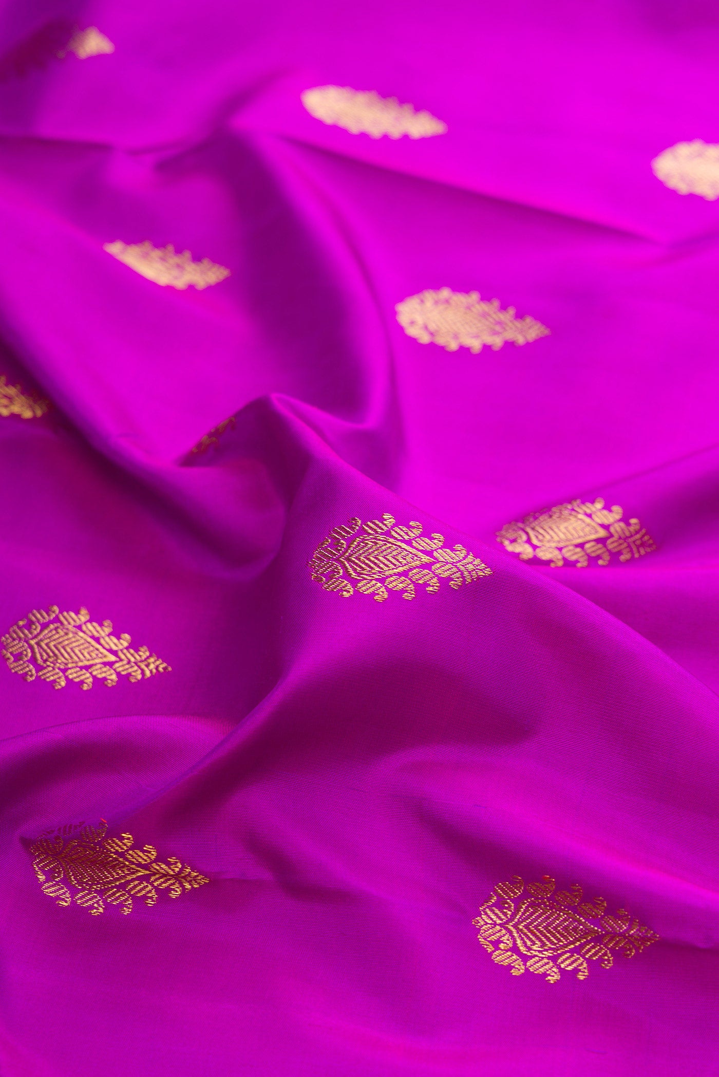 Close up of Pure Silk Pure Zari Purple Kanjivaram Saree with Zari Butta on the body and Fancy Border.  displaying folds