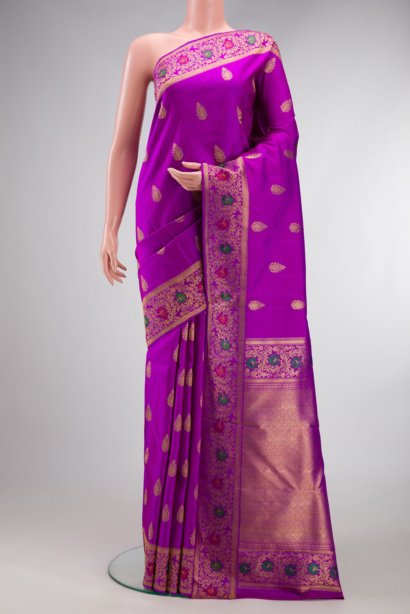 Pure Silk Pure Zari Purple Kanjivaram Saree with Zari Butta on the body and Fancy Border.  displayed on a mannequin