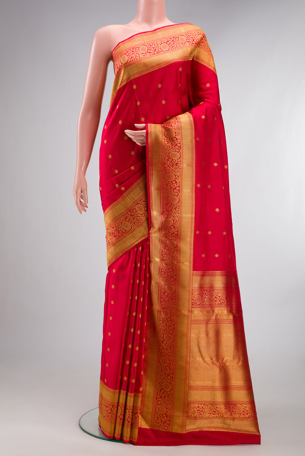 Pure Silk Pure Zari Red Kanjivaram Saree with Zari Butta on the body and Fancy Border.  displayed on a mannequin