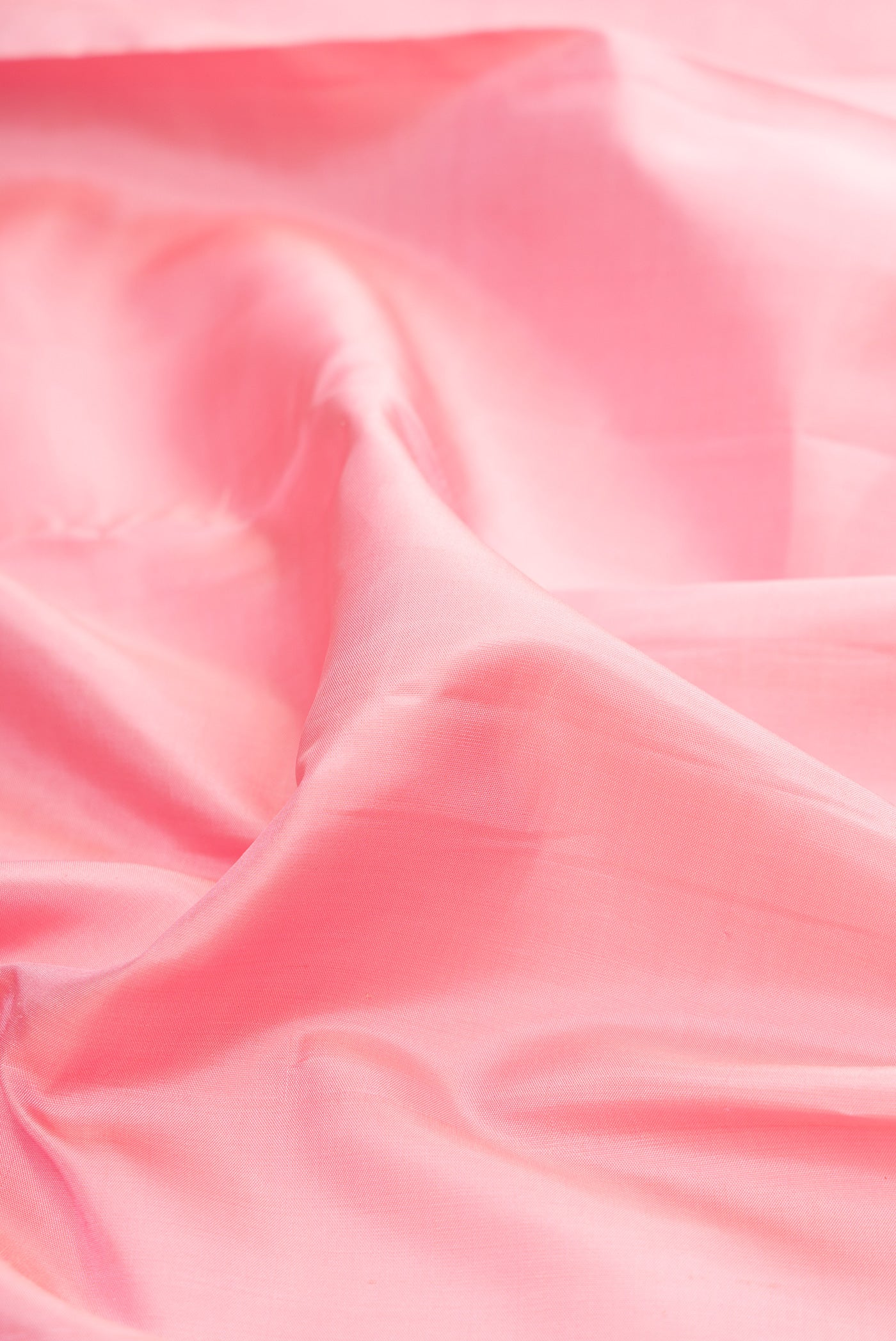 Close up of Rose pink Kanjivaram Silk Saree with Plain Body and Checks Border.  displaying folds