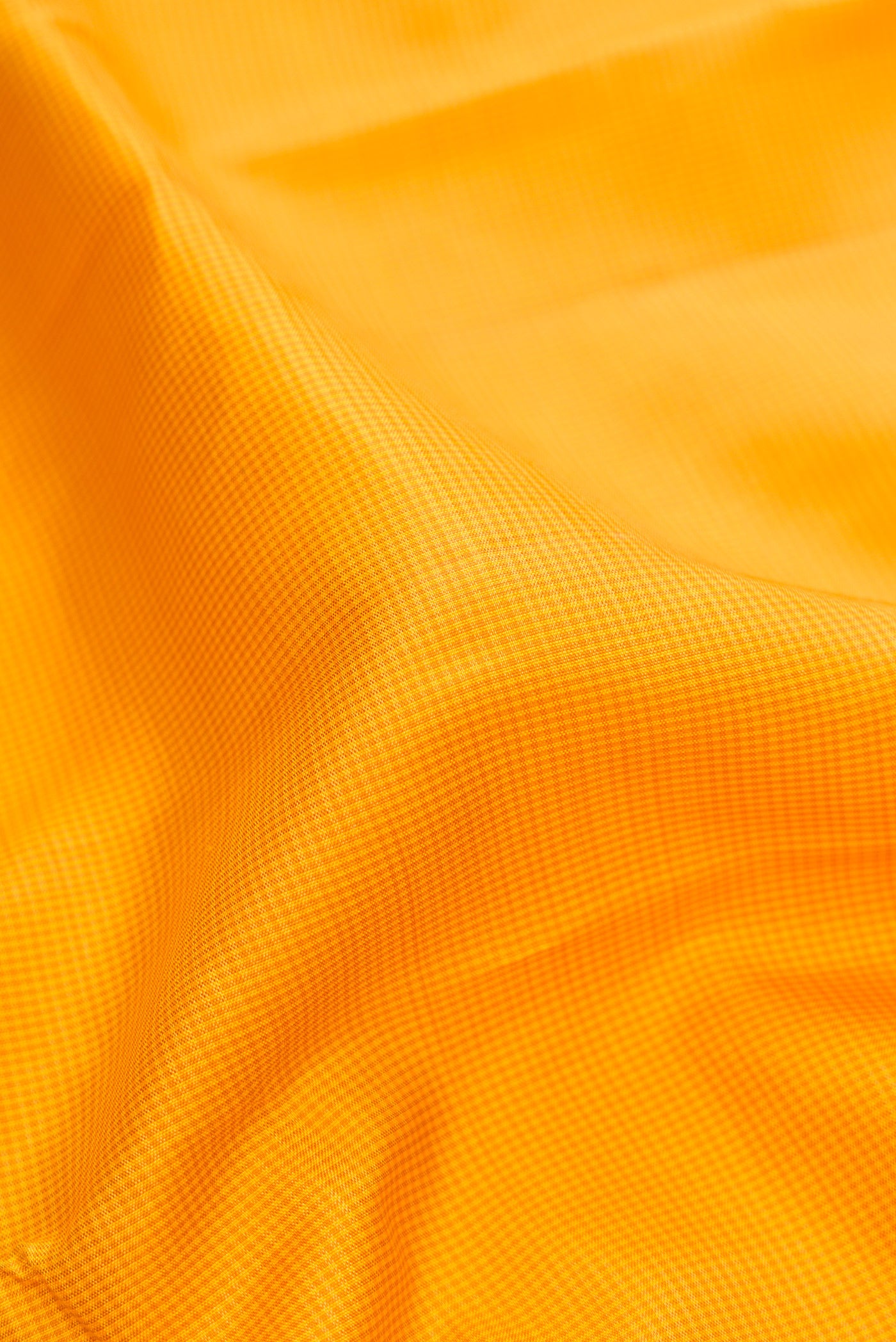 Close up of Yellow Kanjivaram Silk Saree with Checked design on the body and Temple Thread Border.  displaying folds
