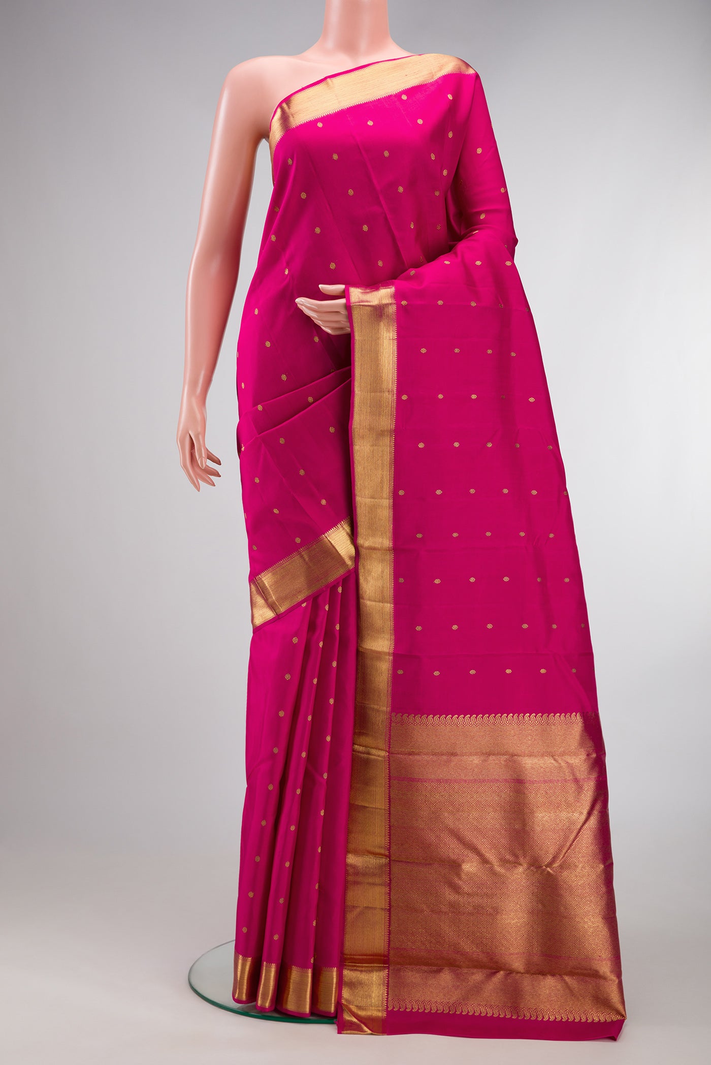Pure Silk Pure Zari Dark Pink Kanjivaram Saree with Zari Butta on the body and Zari Border.  displayed on a mannequin