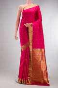 Pure Silk Pure Zari Dark Pink Kanjivaram Saree with Zari Butta on the body and Zari Border.  displayed on a mannequin