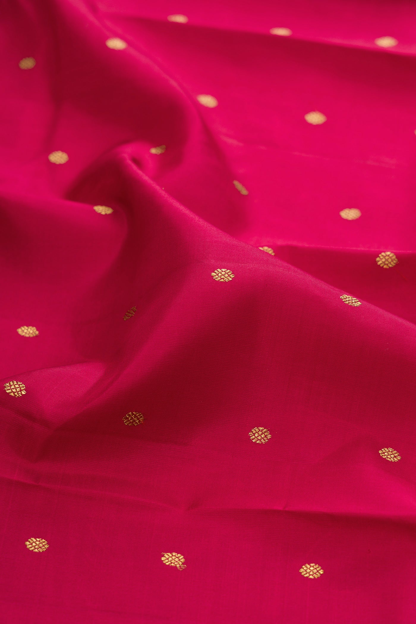 Close up of Pure Silk Pure Zari Maroon Kanjivaram Saree with Zari Butta on the body and Zari Border.  displaying folds
