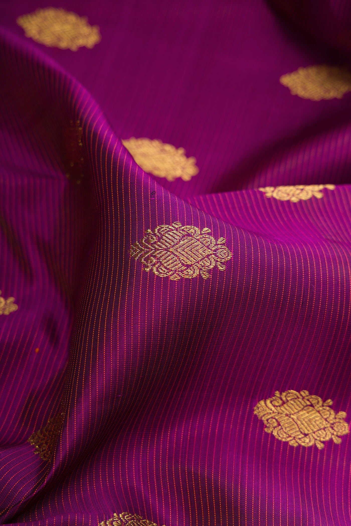 Close up of Pure Silk Pure Zari Purple Kanjivaram Saree with Stripes on the body and Zari Border.  displaying folds