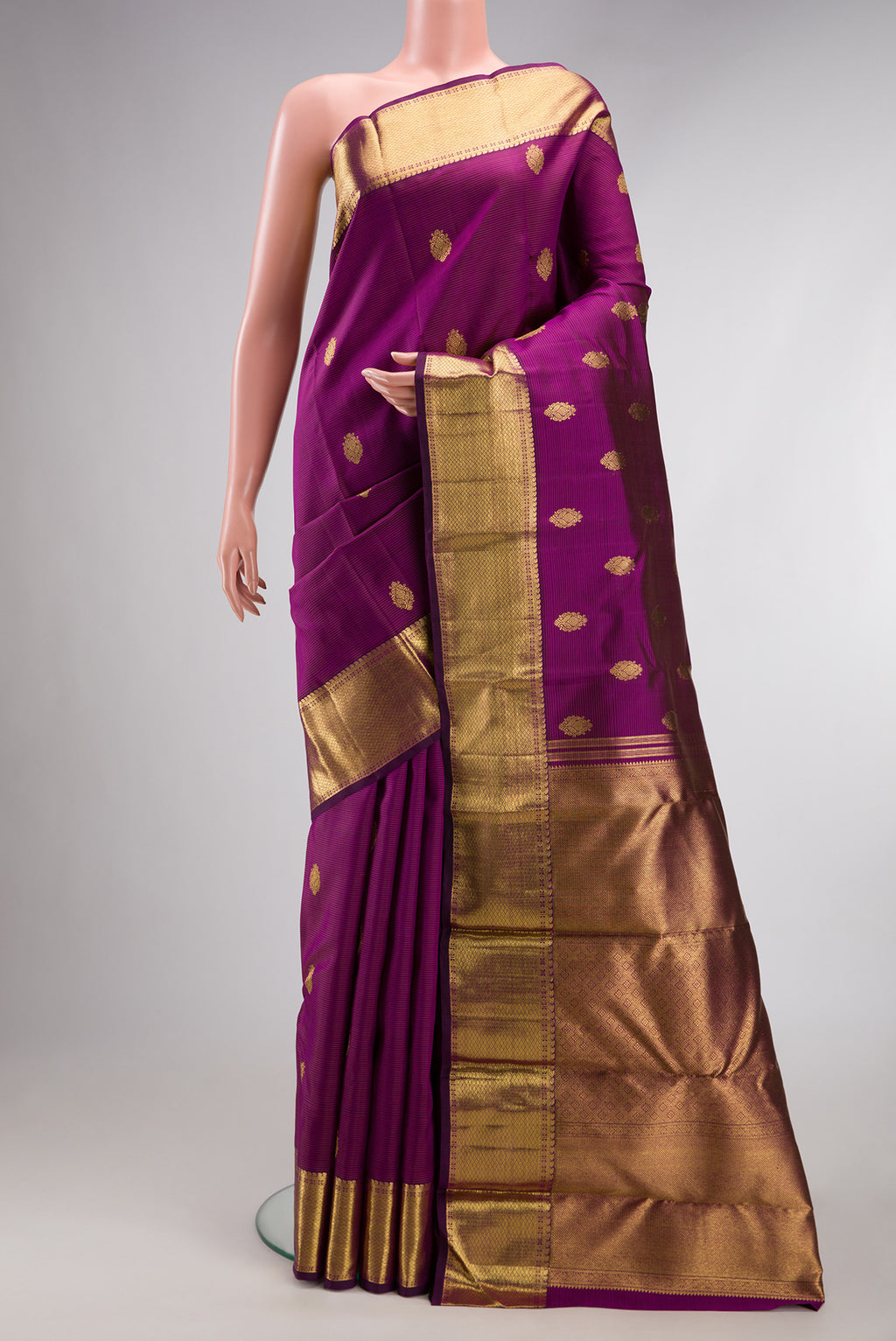 Pure Silk Pure Zari Purple Kanjivaram Saree with Stripes on the body and Zari Border.  displayed on a mannequin