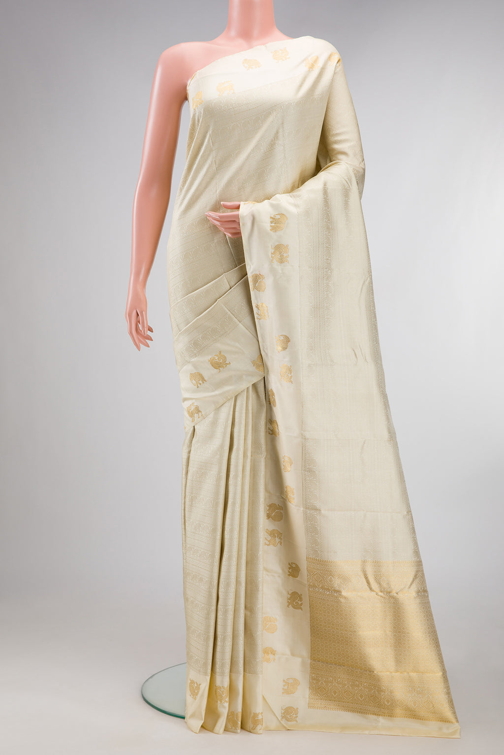 Pure Silk Pure Zari Cream Kanjivaram Saree with Jacquard design on the body and Fancy Border.  displayed on a mannequin
