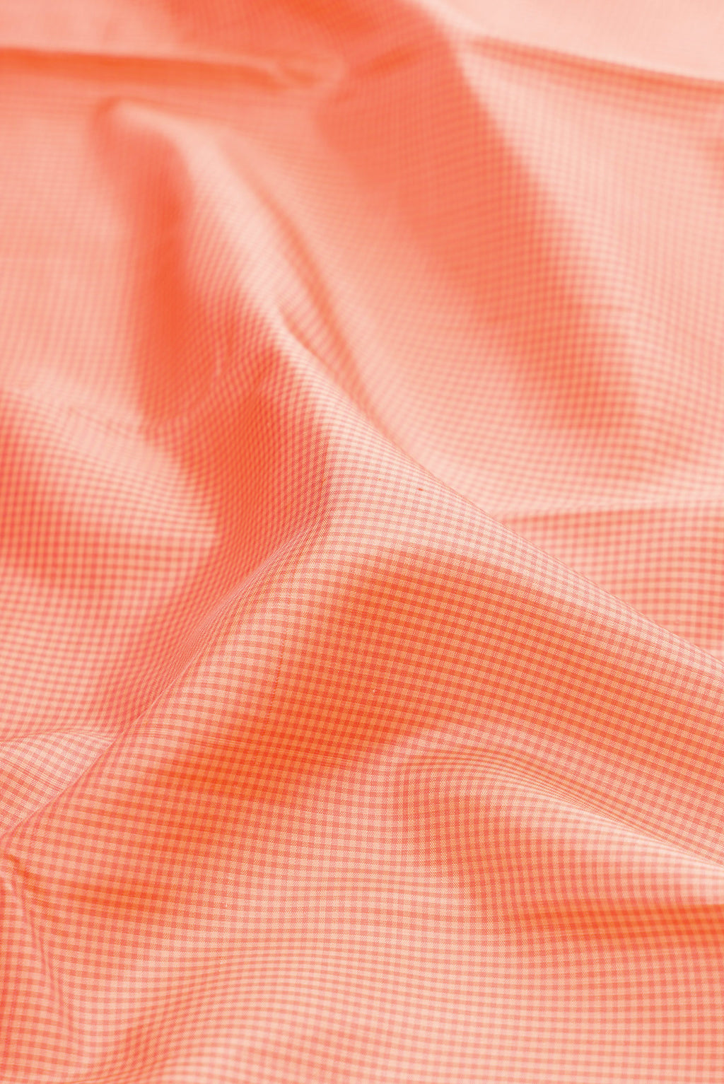 Close up of Peach Kanjivaram Silk Saree with Zari Butta on the body and Plain Border.  displaying folds