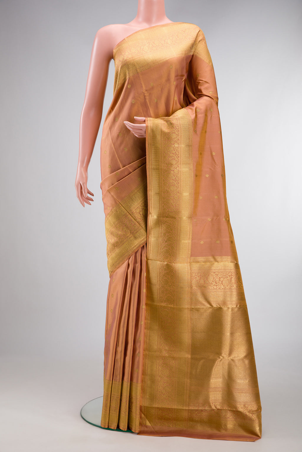 Pure Silk Pure Zari Golden Peach Kanjivaram Saree with Zari Butta on the body and Fancy Border.  displayed on a mannequin