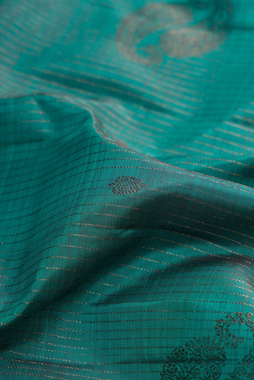 Close up of Teal Kanjivaram Silk Saree with Stripes on the body and Plain Border.  displaying folds