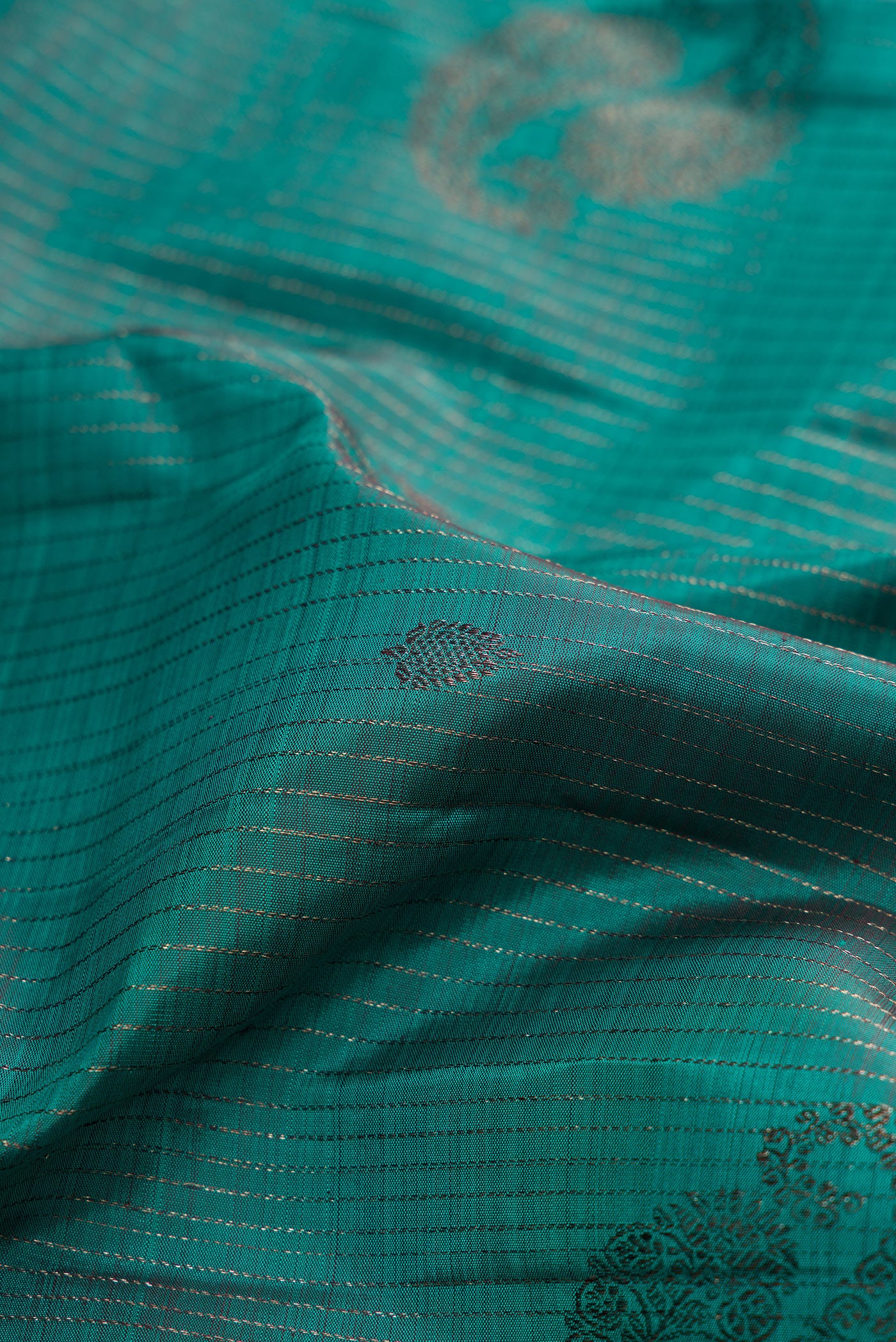 Close up of Teal Kanjivaram Silk Saree with Stripes on the body and Plain Border.  displaying folds