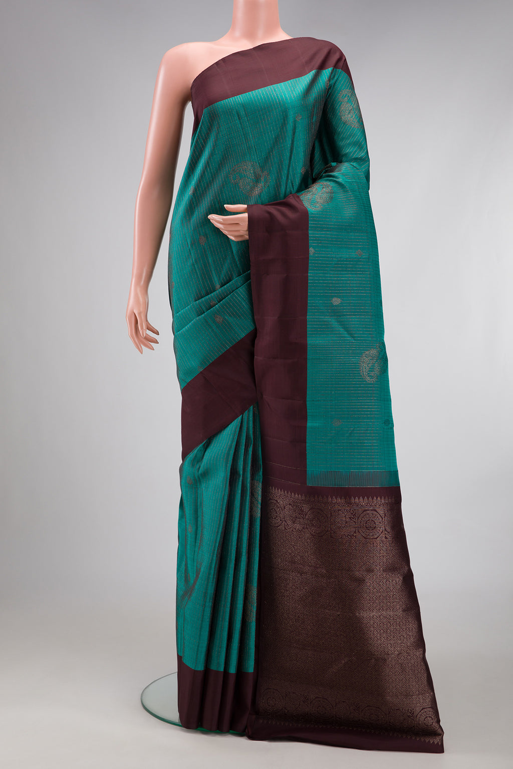 Teal Kanjivaram Silk Saree with Stripes on the body and Plain Border.  displayed on a mannequin