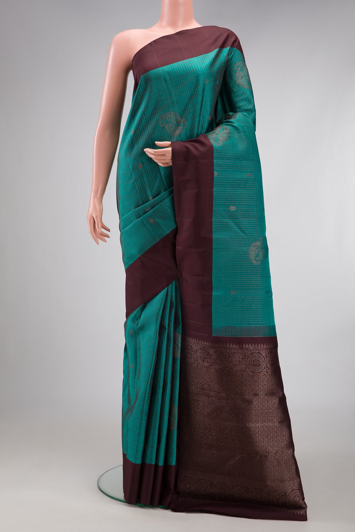 Teal Kanjivaram Silk Saree with Stripes on the body and Plain Border.  displayed on a mannequin