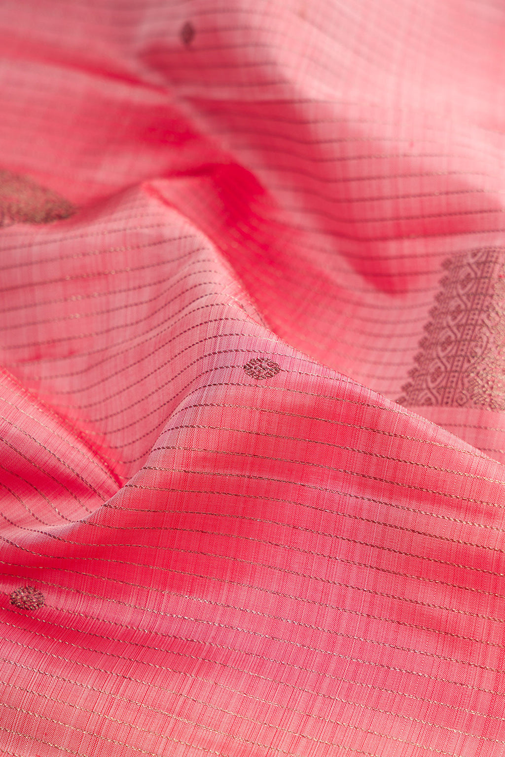 Close up of Pink Kanjivaram Silk Saree with Stripes on the body and Plain Border.  displaying folds