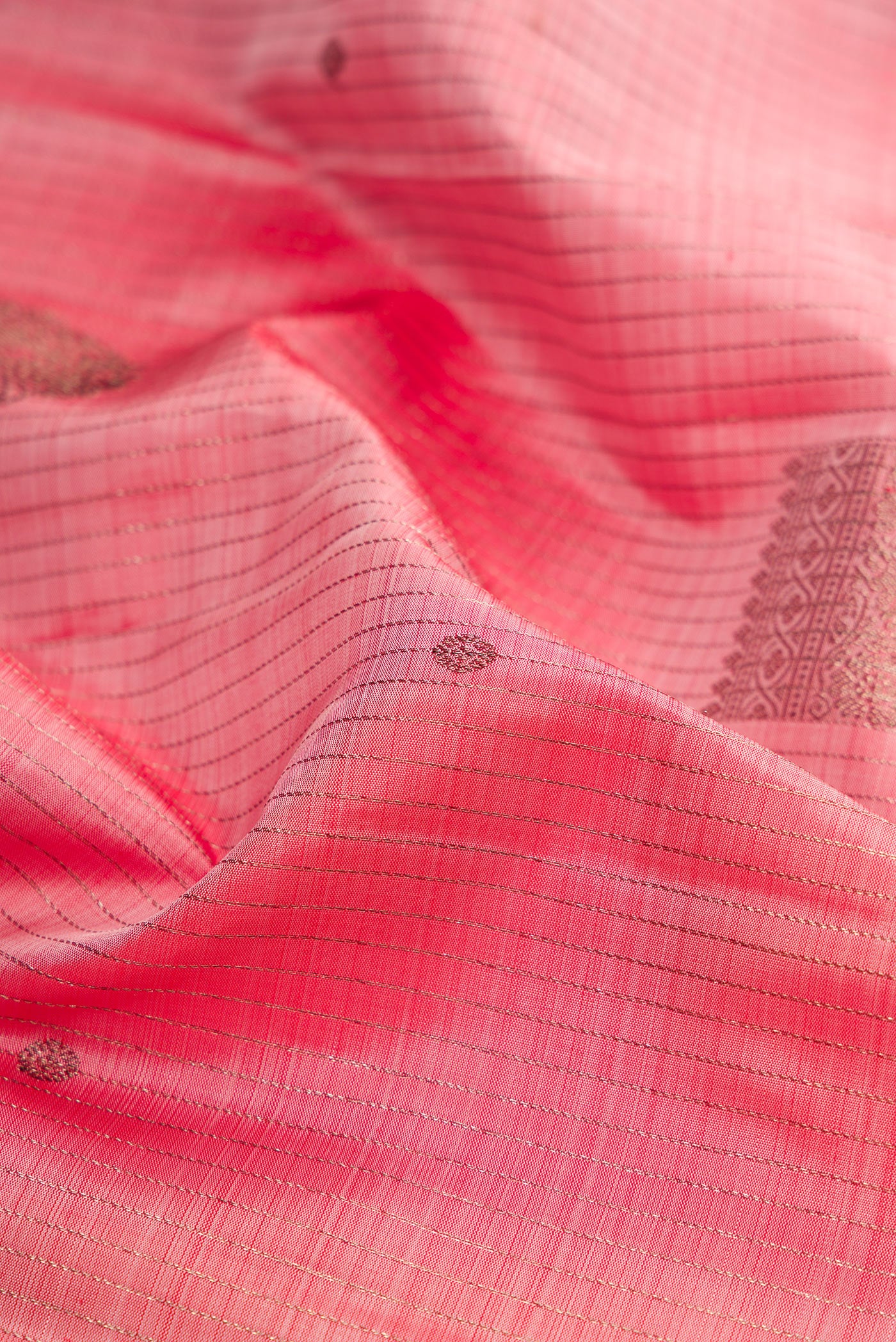 Close up of Pink Kanjivaram Silk Saree with Stripes on the body and Plain Border.  displaying folds