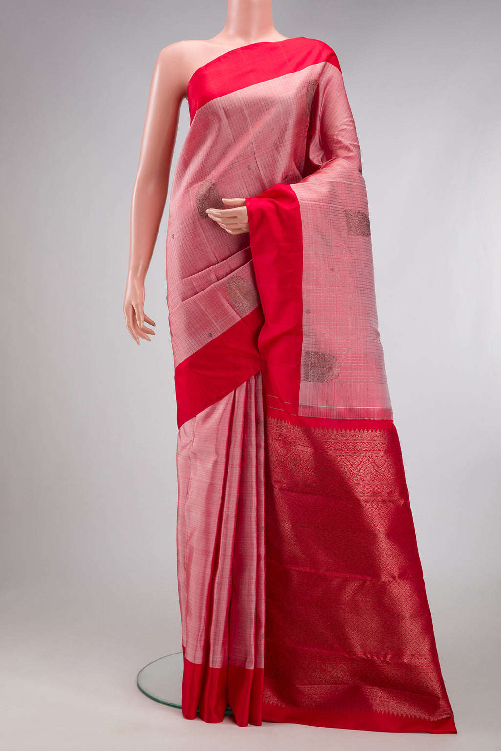 Pink Kanjivaram Silk Saree with Stripes on the body and Plain Border.  displayed on a mannequin