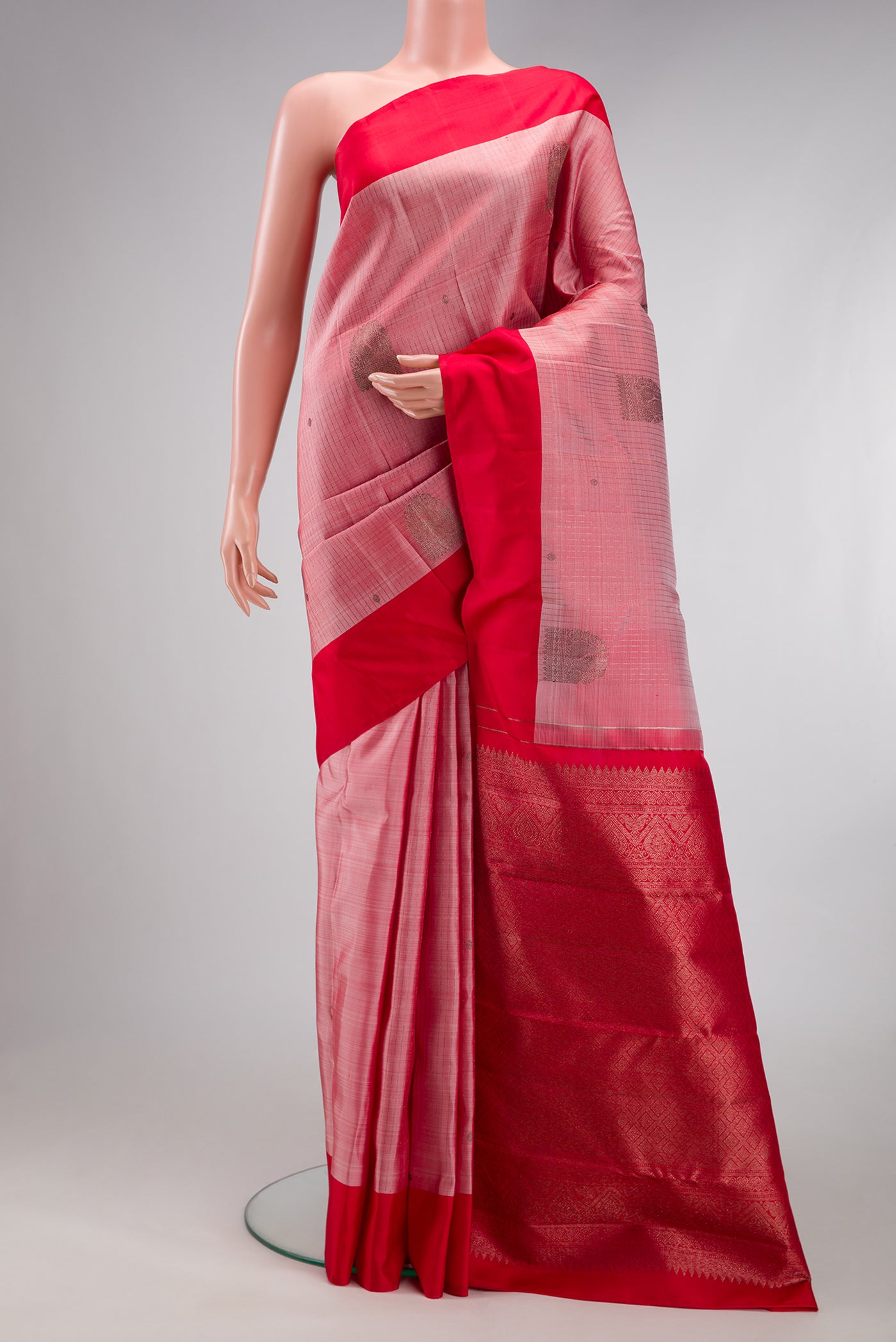 Pink Kanjivaram Silk Saree with Stripes on the body and Plain Border.  displayed on a mannequin