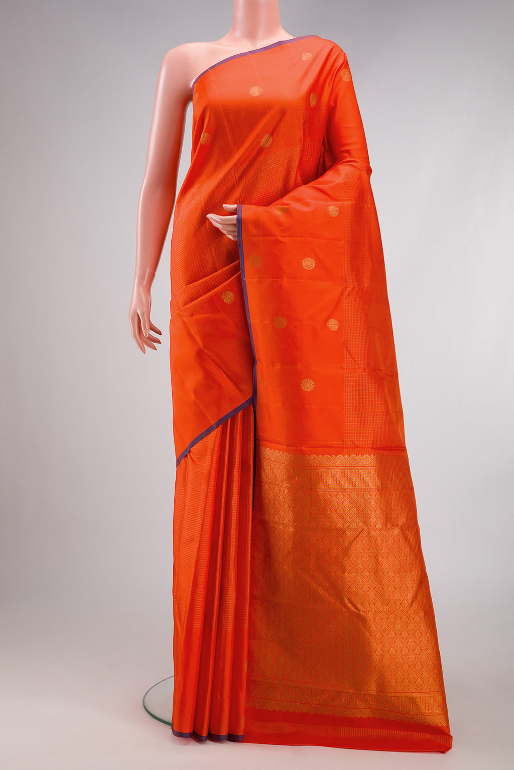 Orange Kanjivaram Silk Saree with Checked design on the body and Fancy Border.  displayed on a mannequin